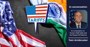 US and Indian flags with "TARIFFS" text in front, featuring Tom Armbruster for an interview on Trump's Tariff strike and the Russia oil dilemma.