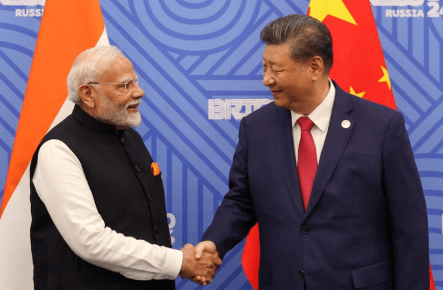 Indian Prime Minister Narendra Modi and Chinese President Xi Jinping shaking hands in front of their respective national flags during a bilateral meeting, highlighting the strategic relationship between India and China.